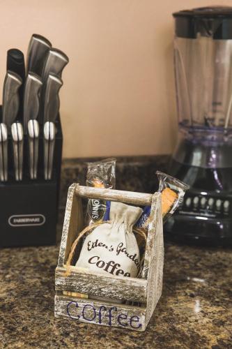 a box of coffee sitting on a counter with a blender at Eden's Garden in Isabela