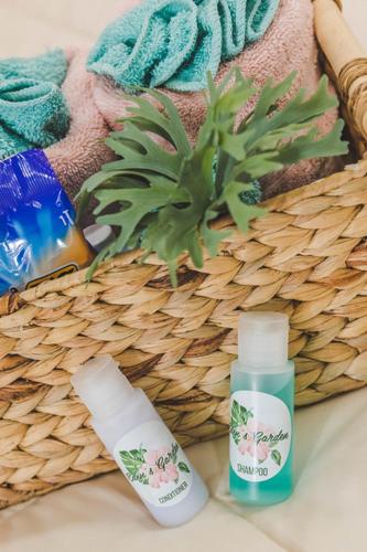 a basket with a bottle of lotion and a bottle of sunscreen at Eden's Garden in Isabela