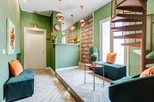 a living room with green walls and a spiral staircase at Ripetta Luxurious Suites in Rome