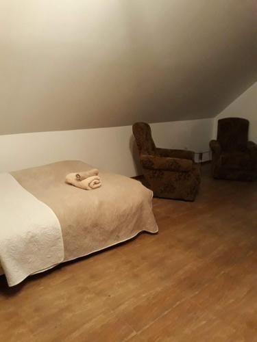 a bedroom with a bed with a towel on it at bizon in Sadowne