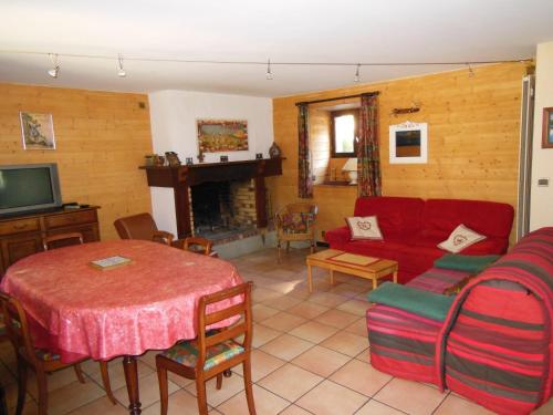 a living room with a red couch and a table at gite tourmalet in Barèges
