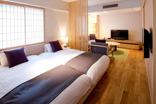 a hotel room with a large bed and a television at Takamatsu Kokusai Hotel in Takamatsu