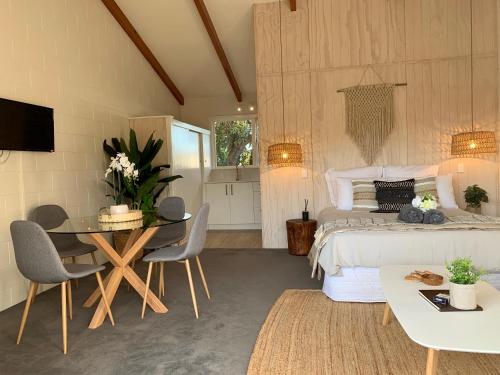 a bedroom with a bed and a table and chairs at Kaikōura Peaks eMotel in Kaikoura