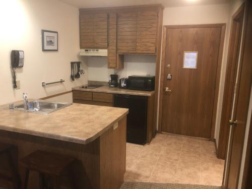a kitchen with a sink and a counter top at The Landing Resort in Egg Harbor