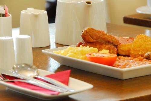 a plate of breakfast food on a table at Grand Royale Hyde Park in London