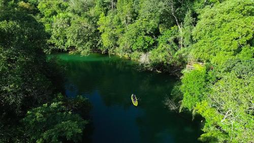 an aerial view of a river with a boat in it at Pousada Boyrá in Bonito