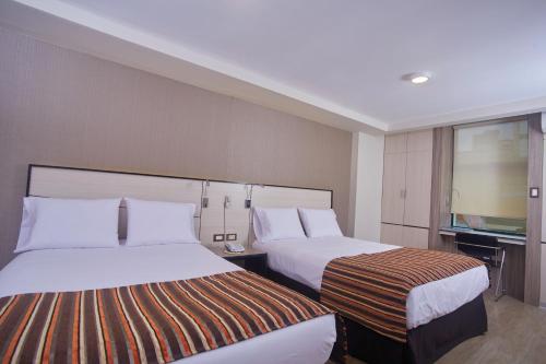 Ένα ή περισσότερα κρεβάτια σε δωμάτιο στο Victoria Regia Hotel