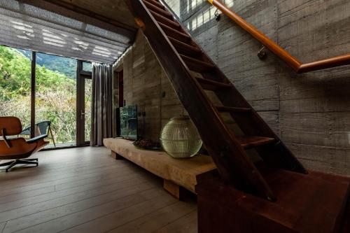 a living room with a aquarium and a wooden floor at Echovilla B&B II in Hualien City