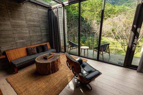 a living room with a couch and a coffee table at Echovilla B&B II in Hualien City