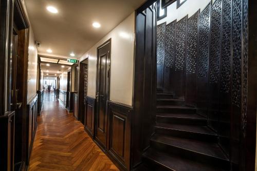 a hallway with wooden floors and stairs in a building at Alisa Premier Cruise in Ha Long