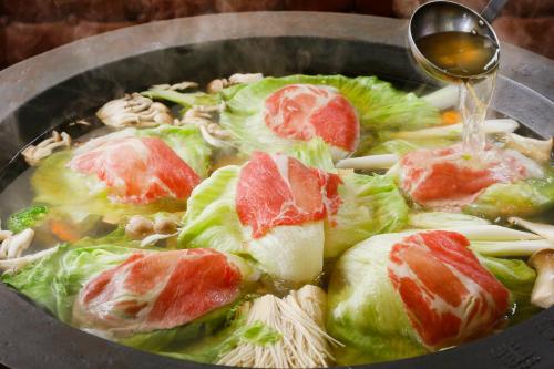 a bowl of soup with meat and vegetables in it at Nanshukan in Kagoshima