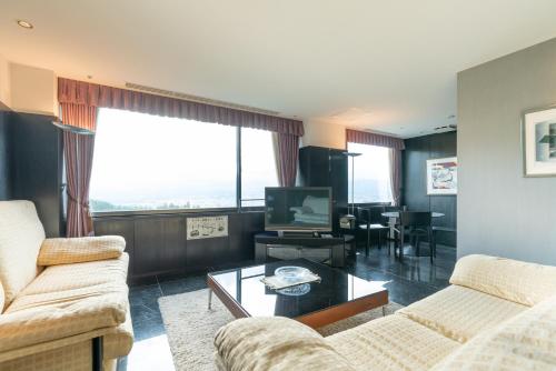 a living room with two couches and a television at Rembrandt Premium Fuji Gotenba in Gotemba