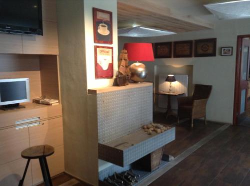 a living room with a fireplace and a television at Hotel Krakonos in Rokytnice nad Jizerou