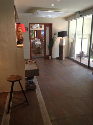 a living room with a wooden floor and a stool at Hotel Krakonos in Rokytnice nad Jizerou