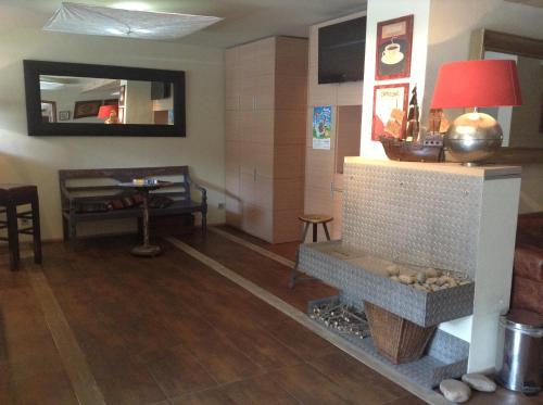 a living room with a fireplace and a table at Hotel Krakonos in Rokytnice nad Jizerou