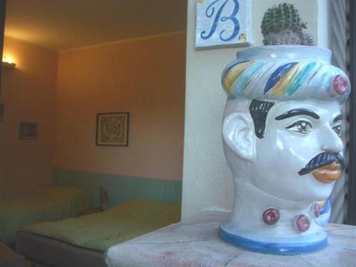 a statue of a head with a face on it at Villa La Spada in Taormina