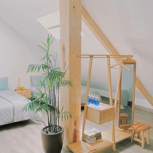 a bedroom with a bed and a potted plant at Tia Du Villa Homestay in Da Lat