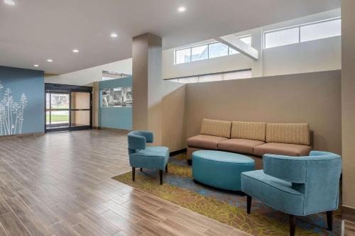a living room with a couch and two chairs at Sleep Inn & Suites Bricktown - near Medical Center in Oklahoma City