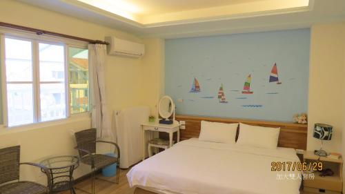 a bedroom with a bed with sails on the wall at 2013 Homestay in Taitung City