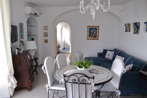 a living room with a table and a blue couch at Villa Anna in Maiori