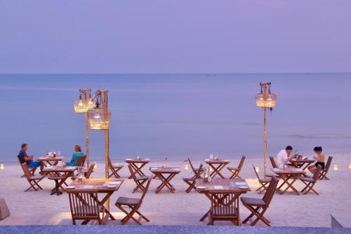 a group of tables and chairs on the beach at Banana Fan Sea Resort - SHA Extra Plus Certified in Chaweng
