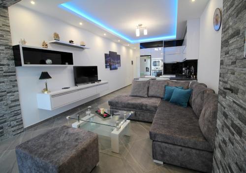 a living room with a couch and a table at Le Gjero luxury villa in Ksamil