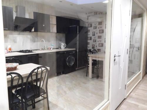 a kitchen with a table and chairs and a sink at GTNL Aparthotel in Tbilisi City