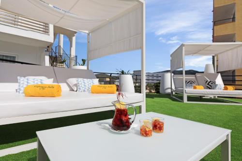 a white table with a drink on a balcony at Palmanova Suites by TRH in Magaluf