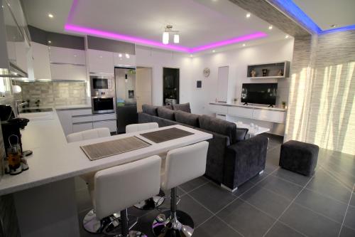 a kitchen and living room with couches and a table at Le Gjero luxury villa in Ksamil