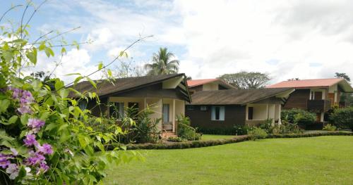 a house with a lawn in front of it at Hotel Eco Arenal in Fortuna