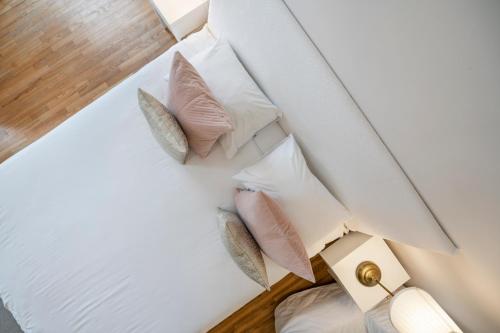 a pile of pillows on a bed in a room at Stepono apartments in Vilnius