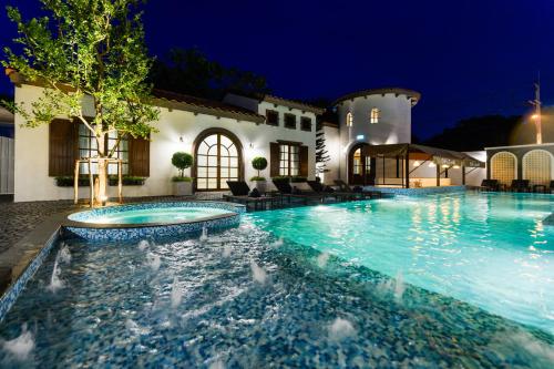 a swimming pool in a house at night at Villa Seville in Hua Hin