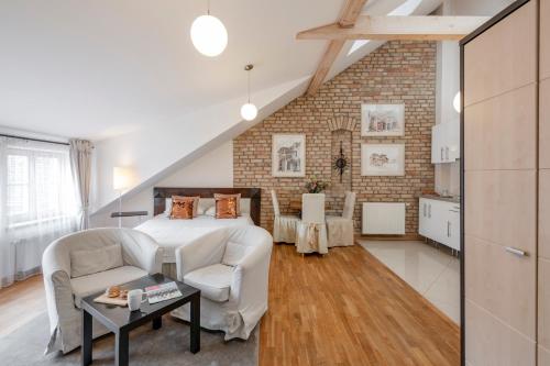 a bedroom with a bed and a brick wall at Stepono apartments in Vilnius