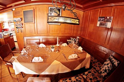 a dining room with a table in a room at Gasthof National in Langendorf