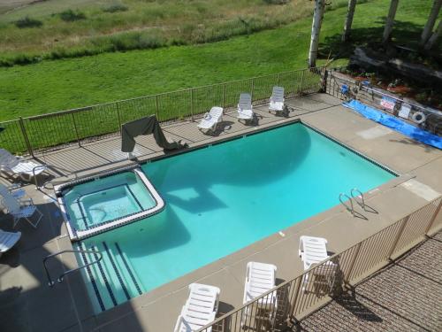 an overhead view of a swimming pool with chairs at Mountain Chalet Snowmass in Snowmass Village