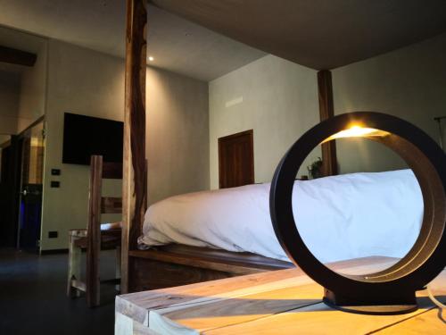 a bedroom with a bed and a mirror on a table at Le 5 Frecce in Cavour