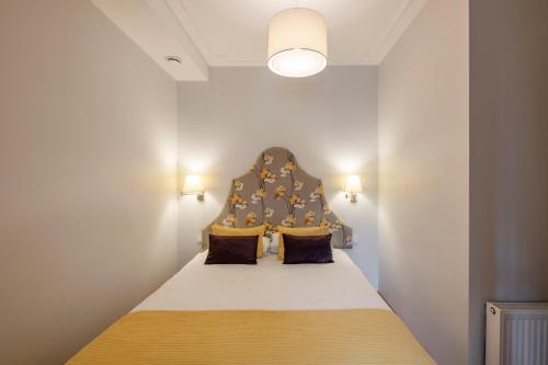 a bed with a headboard in a room at Stepono apartments in Vilnius