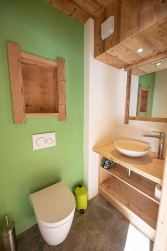 a bathroom with a toilet and a sink at Maison Puy Saint Vincent in Puy-Saint-Vincent