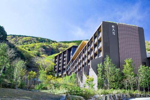 a hotel on a hill next to a river at Hakone Kowakien Tenyu in Hakone