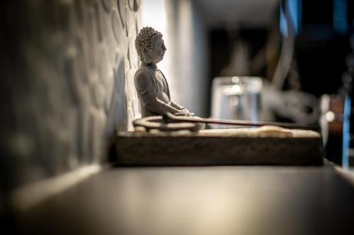 a small statue sitting on a counter next to a wall at SL'otel - Das StadtHotel - voll Klimatisiert in Bernburg