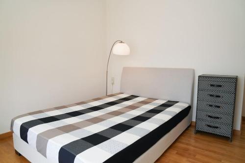 a bedroom with a bed with a black and white checkered blanket at Casa Minervos in Áptera