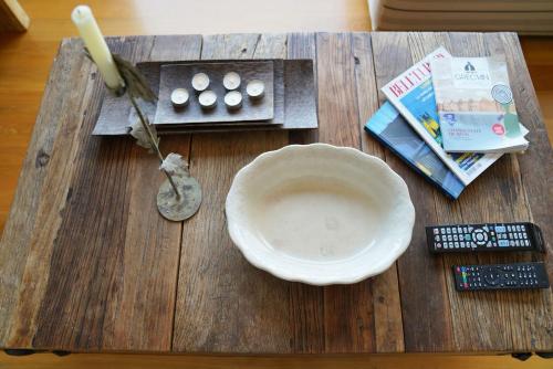 a wooden table with a bowl and a remote control at Casa Minervos in Áptera