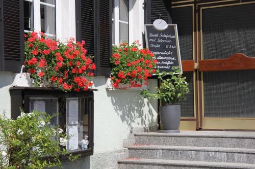 a building with flower boxes and a sign on it at Landgasthof Ochsen in Sinzheim