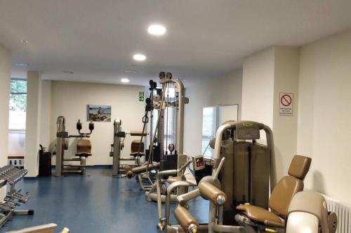 a gym with a bunch of treadms and machines at Ferienwohnung Marion in Sankt Englmar
