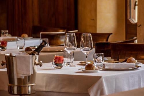 a set of tables with wine glasses on them at Albergo Le Due Corti in Como