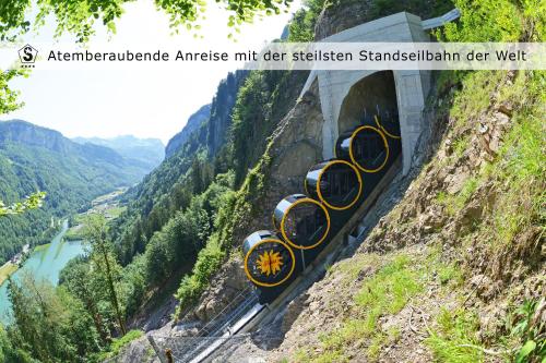 a train coming out of a tunnel on a mountain at Fronalpstock Hotel & Restaurant in Stoos