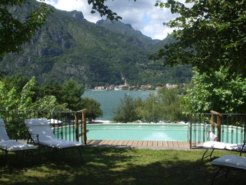 a swimming pool with a view of a lake at Residence Antico Crotto in Porlezza