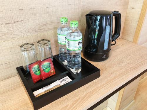 a counter with bottles of water and a coffee maker at Chotel Ben Thanh in Ho Chi Minh City