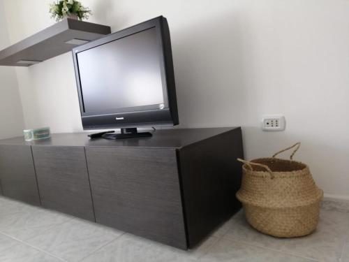 a television sitting on top of a black cabinet at Casa Grazia in Crispiano