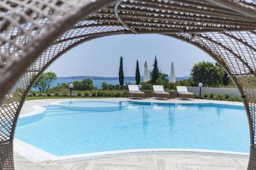 a large swimming pool with lounge chairs and avationliest at Azur Apartment Deluxe in Chernomorets